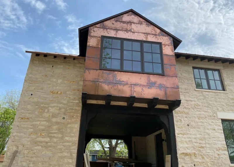 Copper metal panel facade on a stone building for Skylight Installation in Royal Kunia